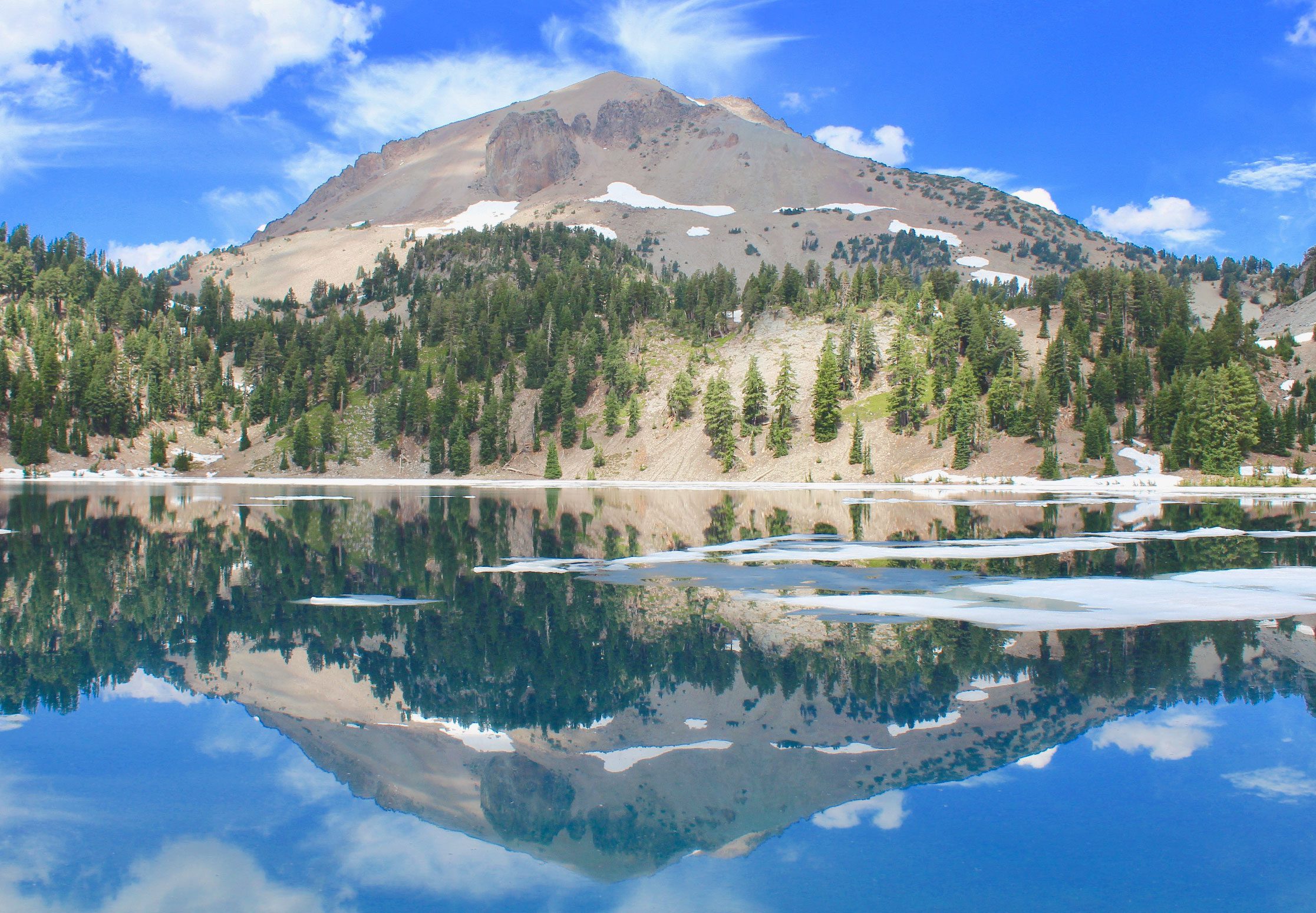 A mountain reflected in a lake on a Green Tortoise adventure tour