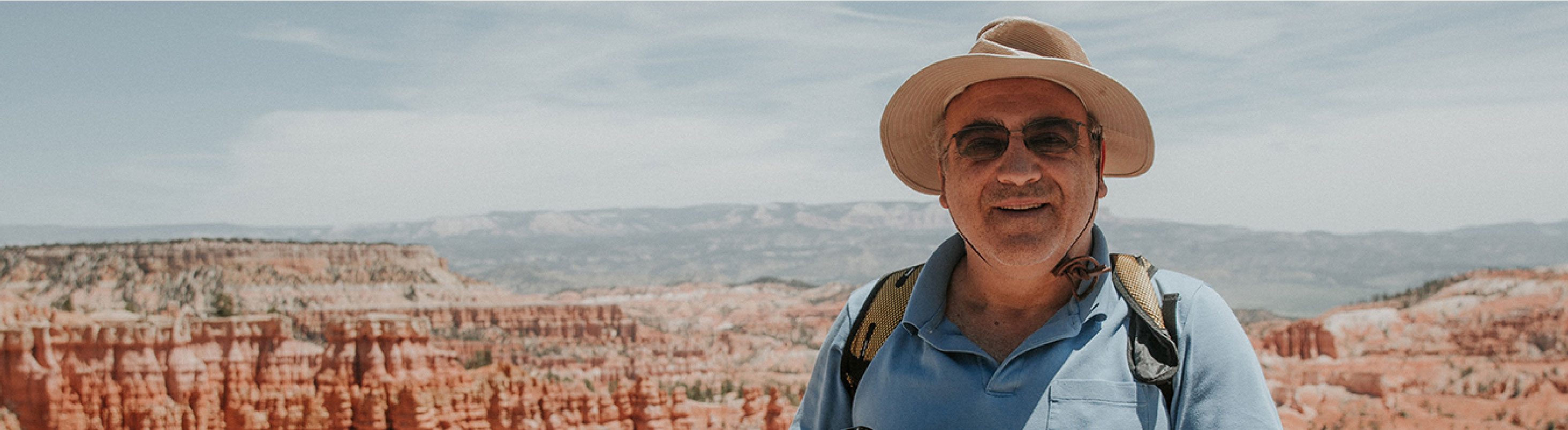 A man poses for a photo at Bryce Canyon on a Green Tortoise camping tour