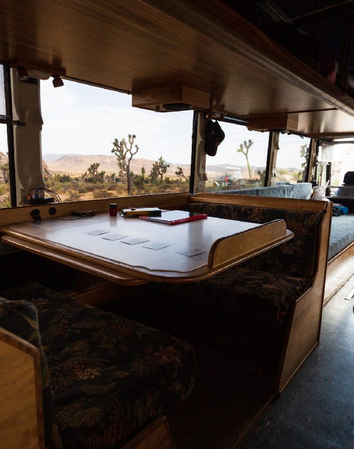 A Green Tortoise adventure bus has a unique interior. Sit at dinette tables or lounge on the back platform on our group camping tours.