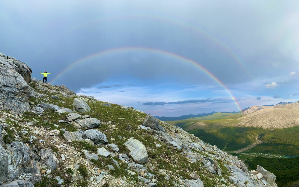 A rainbow over a rocky ridge on a hiking trail in the Yukon Territory