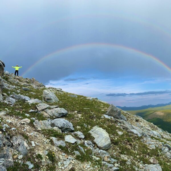 A rainbow over a rocky ridge on a hiking trail in the Yukon Territory