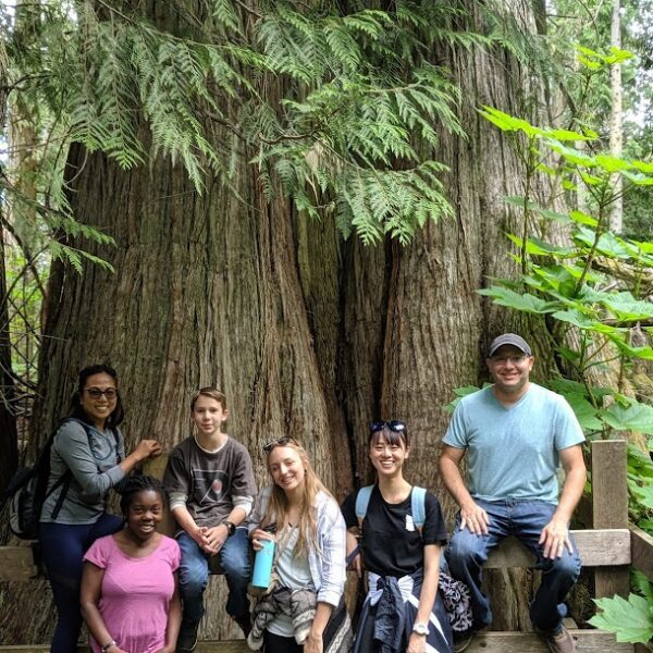 Green Tortoise group poses in front of massive tree