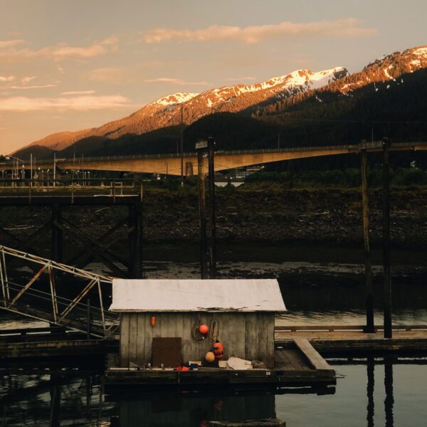 A dock at sunset with Alaska Experience across the photo
