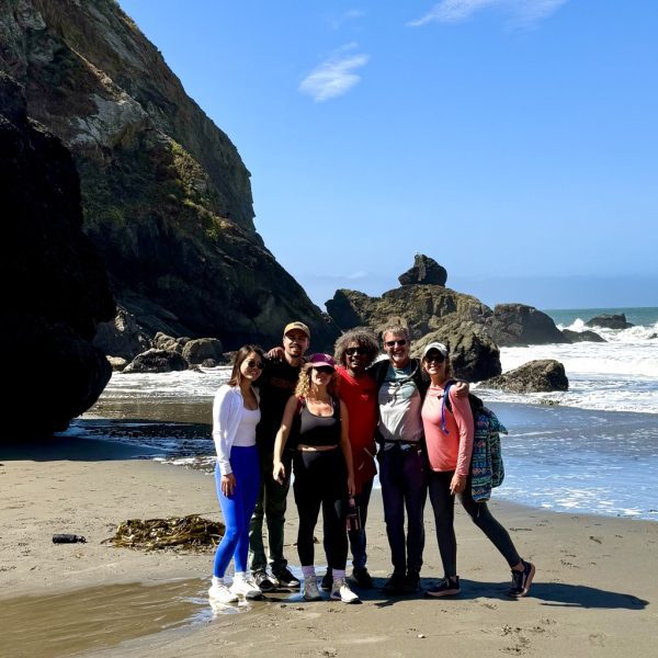 Group poses for a photo on a California Beach