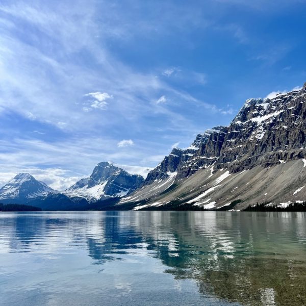 The Canadian Rockies reflecting on a lake on a Green Tortoise adventure.