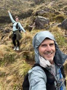 A man and a woman smiling in raincoats