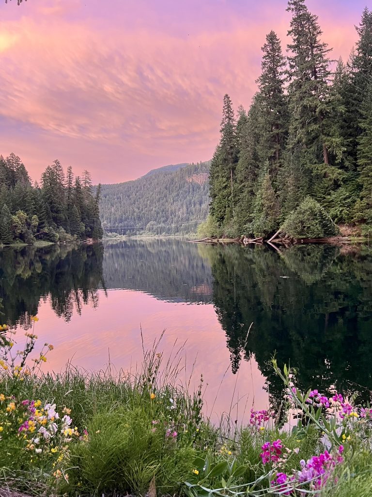 A colorful sunset over a lake in Oregon on a camping adventure.