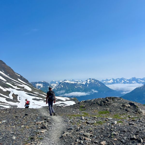 A man and a woman on a hiking trail in Kenai Fjords National Park
