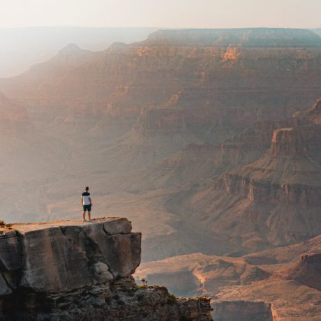 Man stands overlooking the Grand Canyon on the National Parks Loop adventure.